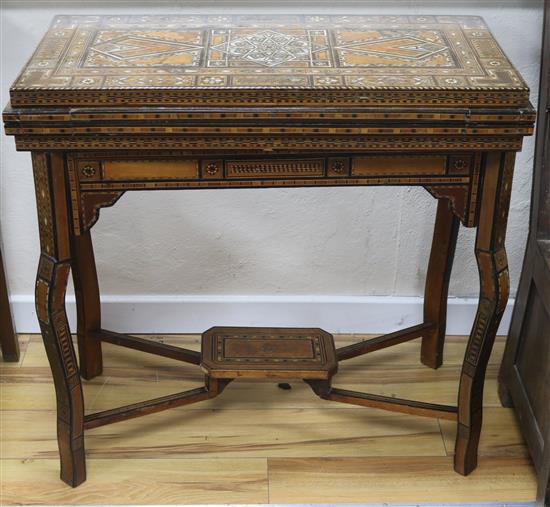 A Damascus ware games table, W.84cm